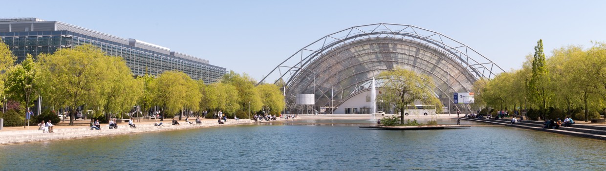 The glass hall of the Leipzig Trade Fair. The trade fair lake in the foreground. The glass hall of the Leipzig Trade Fair. The trade fair lake in the foreground.