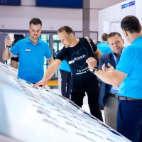 Two trade fair visitors have a consultation at a trade fair stand.