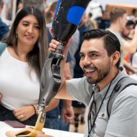 A person holds a prosthetic leg in their hand.