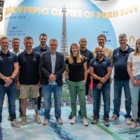 Group photo in front of a banner for the Paralympic Games of Paris 2024