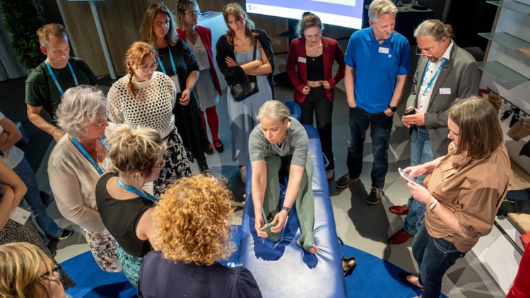 A woman in the center of the picture presents special stockings to numerous interested parties.