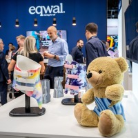 Two colorful, beautifully designed support corsets for children, with a teddy bear next to them.