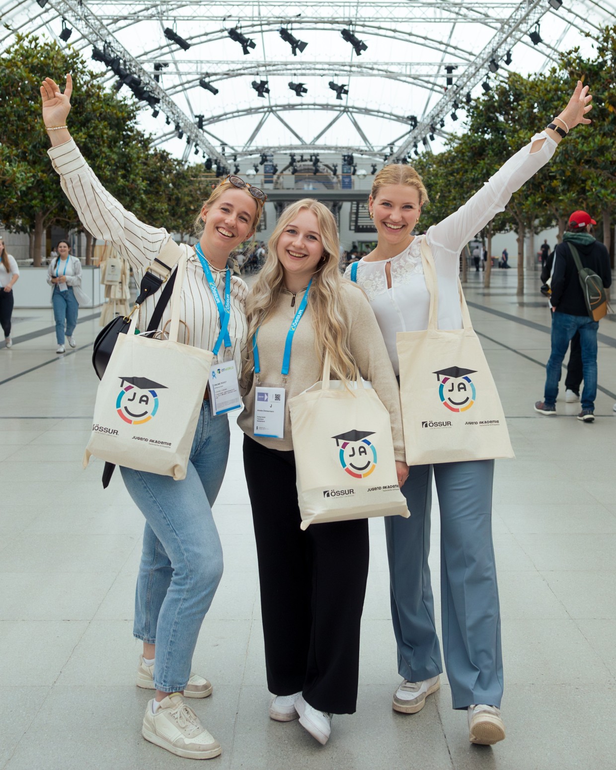 Youth.academy TO: Three participants of the Youth Academy TO 2024 pose in the glass hall